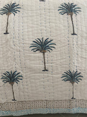 Blue Palms on white, slightly padded cotton quilt