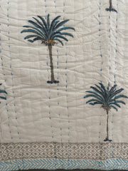 Blue Palms on white, slightly padded cotton quilt