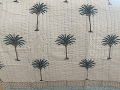 Blue Palms on white, slightly padded cotton quilt