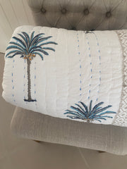 Blue Palms on white, slightly padded cotton quilt