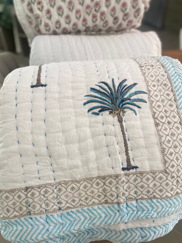 Blue Palms on white, slightly padded cotton quilt