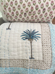 Blue Palms on white, slightly padded cotton quilt